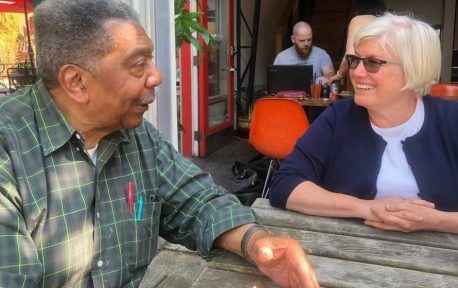 harvey-loulie- Harvey Rice and Loulie Brown having a conversation sitting down at a table